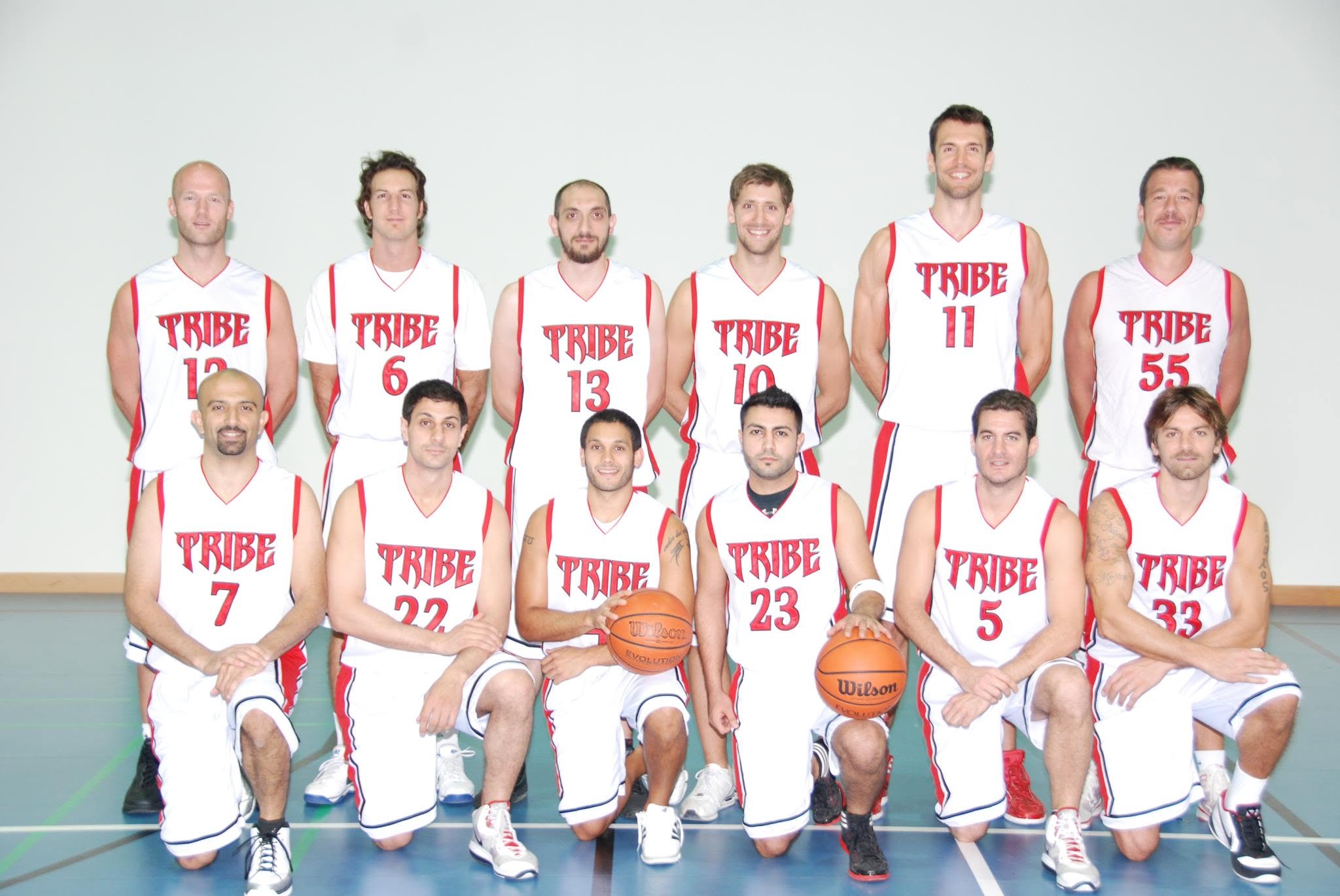 Brian Sigafoos and the Dubai Tribe basketball team in white uniforms